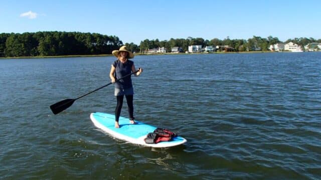 girl using stand up paddleboard va beach